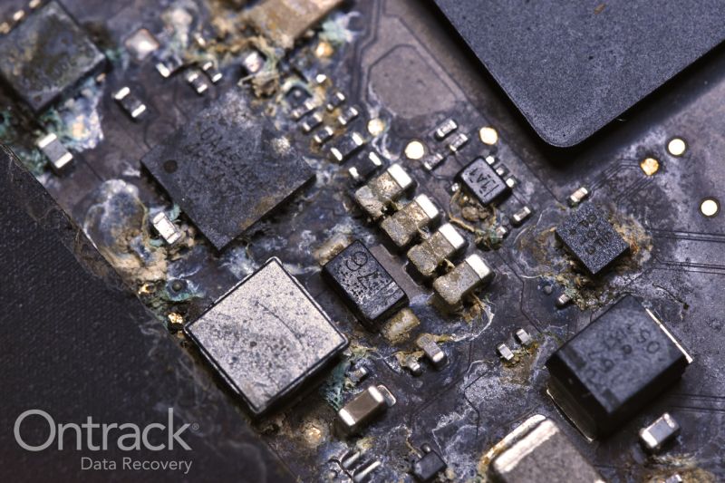 Water-damaged logic board undergoing board-level remediation and rework